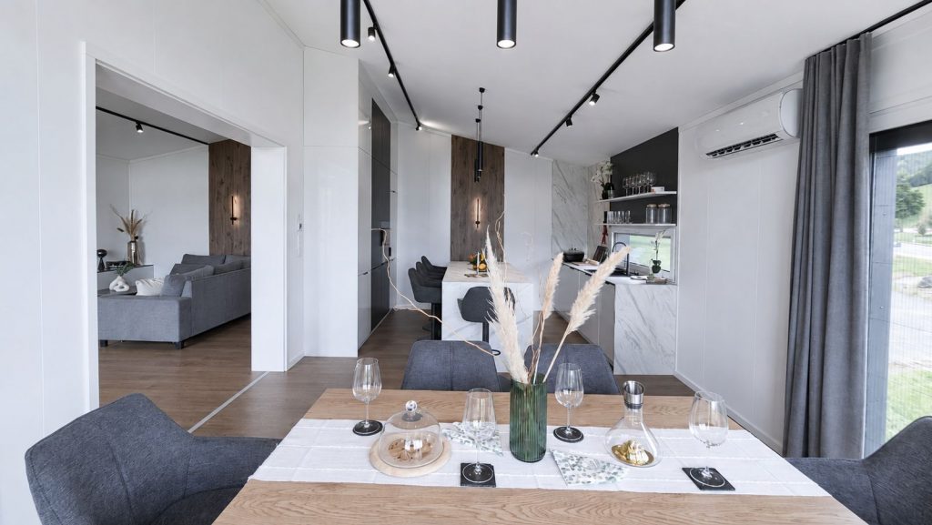 Essbereich mit gedecktem Holztisch, Designerstühlen und Blick zur Marmorküche - stilvoll vollmöbliert.